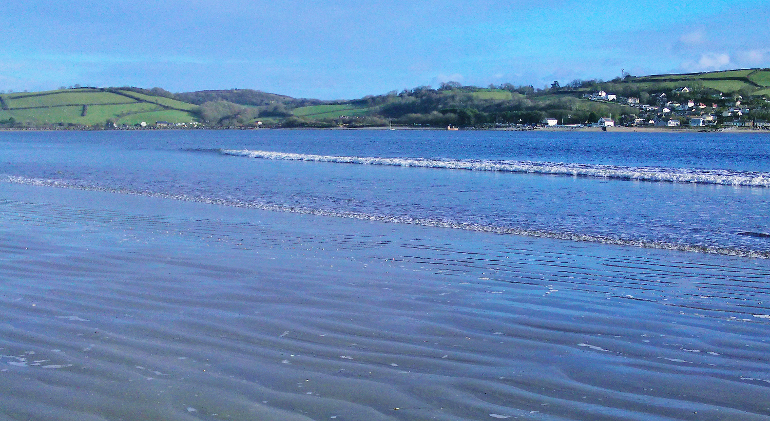 Sunny day image of Llansteffan beach looking out towards Ferrytown, South Wales